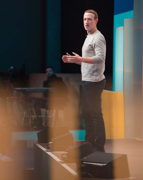 A person standing on a stage  Description automatically generated with medium confidence